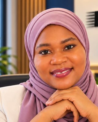 Portrait of Fatima Lawal, wearing a lilac hijab and cream jacket.